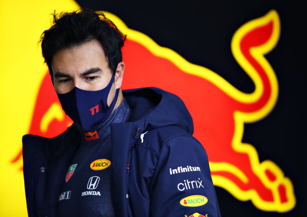 NORTHAMPTON, ENGLAND - FEBRUARY 22: Sergio Perez of Mexico and Red Bull Racing prepares to drive in the garage during the Red Bull Racing filming day at Silverstone on February 22, 2021 in Northampton, England. (Photo by Mark Thompson/Getty Images for Red Bull Racing)