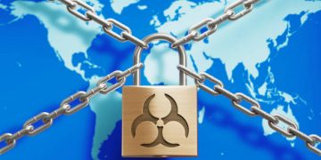 Padlock and chain on geographical world map, Horizontal composition with copy space. COVID-19 pandemic lock down and social distancing concept.