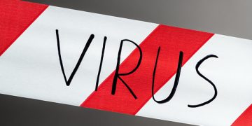 Label virus. Red and white warning tape with the inscription virus close up on black background. Concept for protecting people from coronavirus infection. Coronavirus, Covid-19