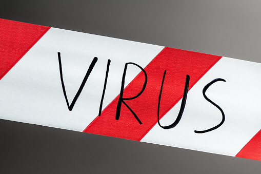 Label virus. Red and white warning tape with the inscription virus close up on black background. Concept for protecting people from coronavirus infection. Coronavirus, Covid-19