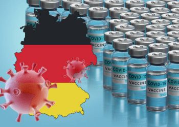 Germany to launch COVID-19 vaccination campaign. Coronavirus vaccine vials, Covid 19 cells, map and flag of Germany on blue background. Fighting the epidemic. Research and creation of a vaccine.