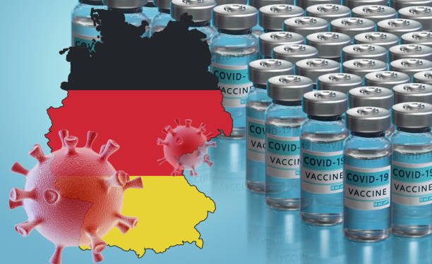 Germany to launch COVID-19 vaccination campaign. Coronavirus vaccine vials, Covid 19 cells, map and flag of Germany on blue background. Fighting the epidemic. Research and creation of a vaccine.