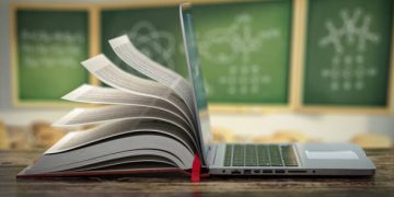 E-learning online education or internet  encyclopedia concept. Open laptop and book compilation in a classroom. 3d illustration
