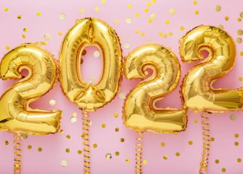 2021 year gold balloons on ribbons with confetti on pink wall. Happy New year 2021 eve celebration.