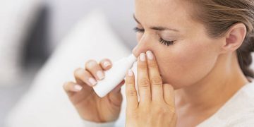 Woman using nasal drops