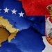 flags of Kosovo and Serbia painted on cracked wall