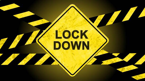 LOCKDOWN lettering on a warning sign with warning tapes striped in black and yellow against a black background - 3D illustration