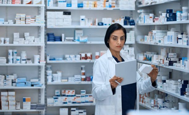 Shot of a young woman using a digital tablet to do inventory in a pharmacy